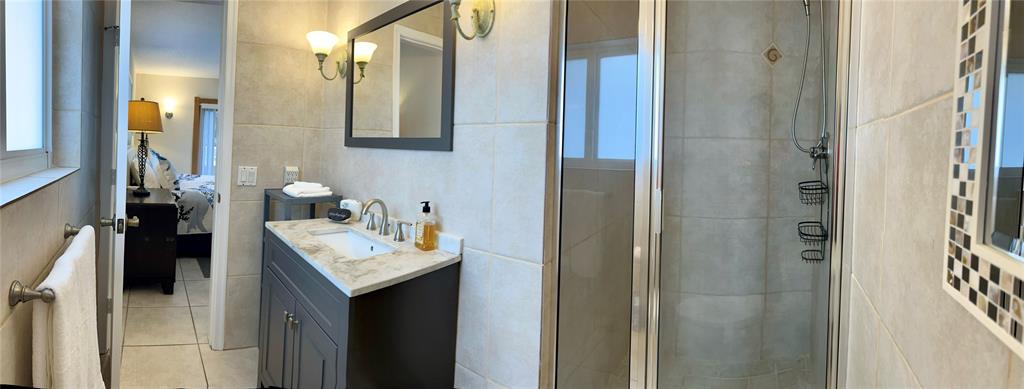 5911 Northeast 15th Avenue Fort Lauderdale, FL 33334 - Photo 6 of 21 a bathroom with a sink vanity and a mirror