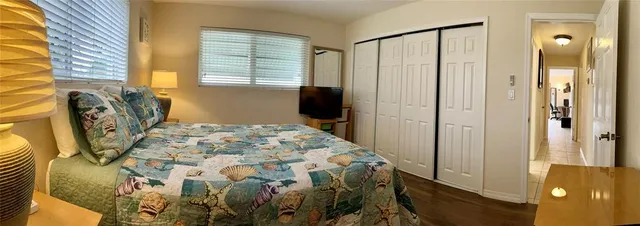 a bedroom with a bed a mirror and a window