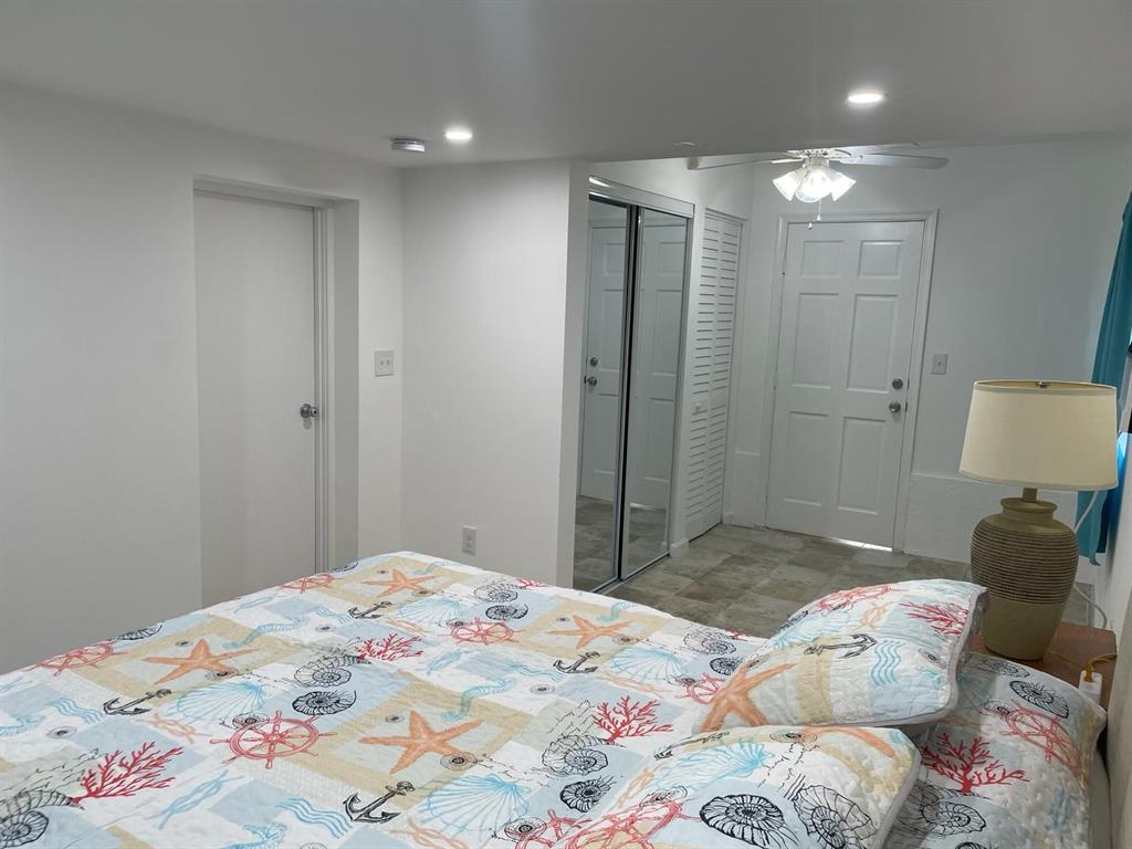 5911 Northeast 15th Avenue Fort Lauderdale, FL 33334 - Photo 9 of 21 a bedroom with a bed and a mirror