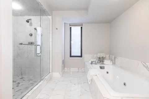 a bathroom with a bathtub and shower
