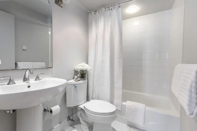a bathroom with a sink toilet and shower