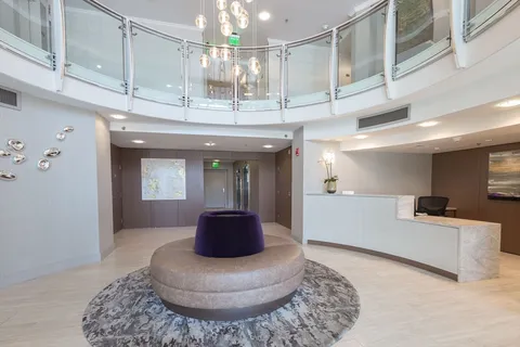 a lobby with furniture and a chandelier