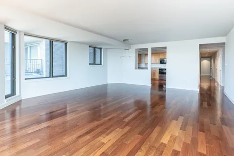 a view of empty room with wooden floor and fireplace