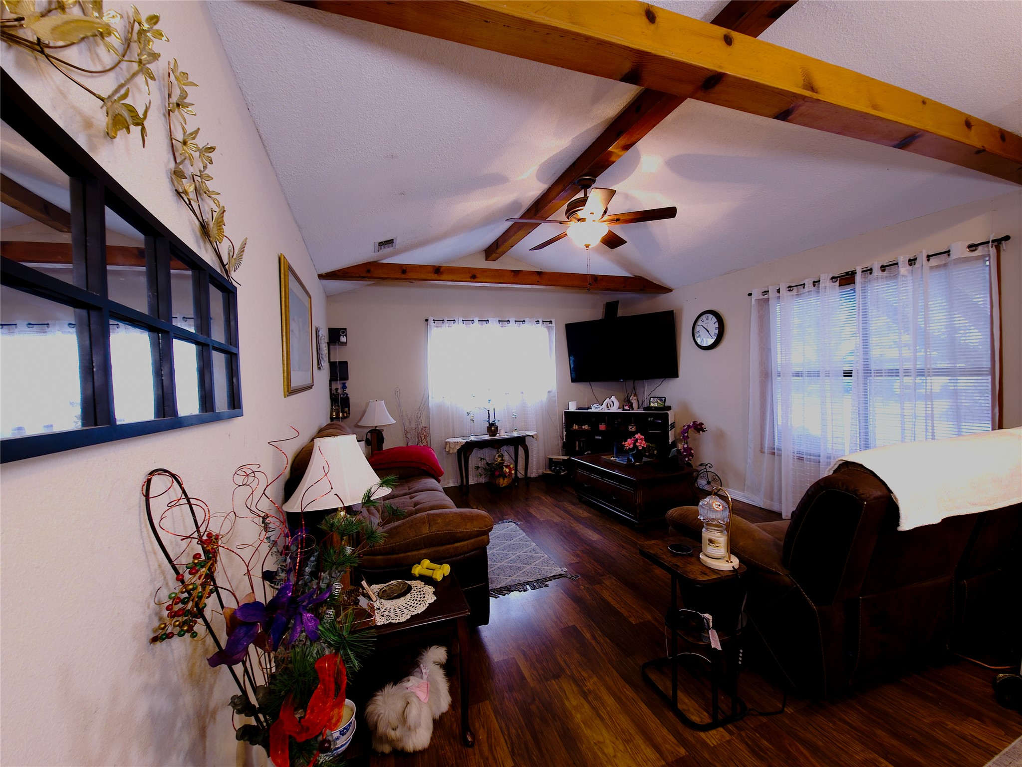 911 Brazos Street Lockhart, TX 78644 - Photo 9 of 22 Living room with ceiling fan, dark wood-type flooring, and beam ceiling