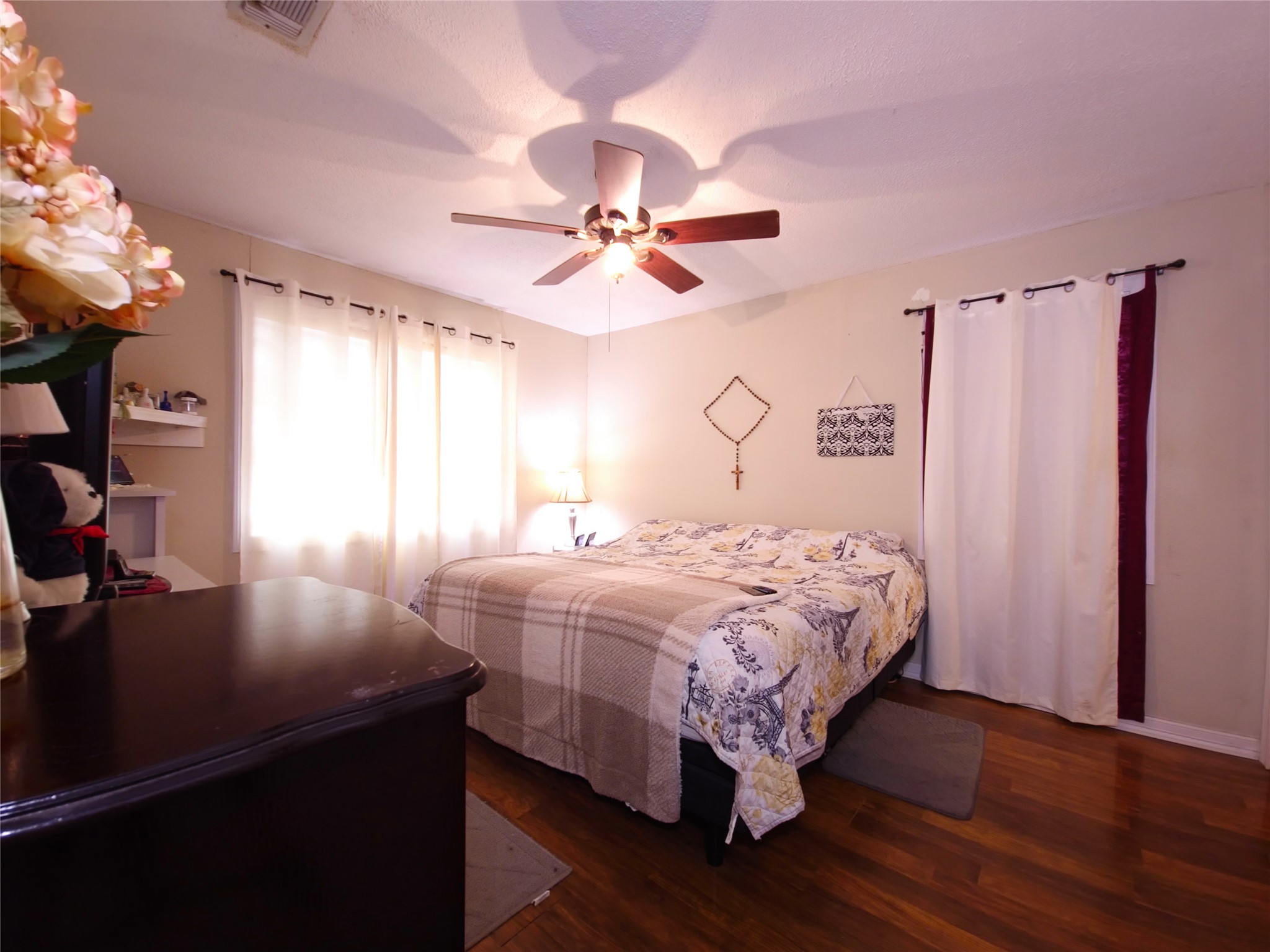 911 Brazos Street Lockhart, TX 78644 - Photo 10 of 22 Bedroom with dark wood finished floors and ceiling fan