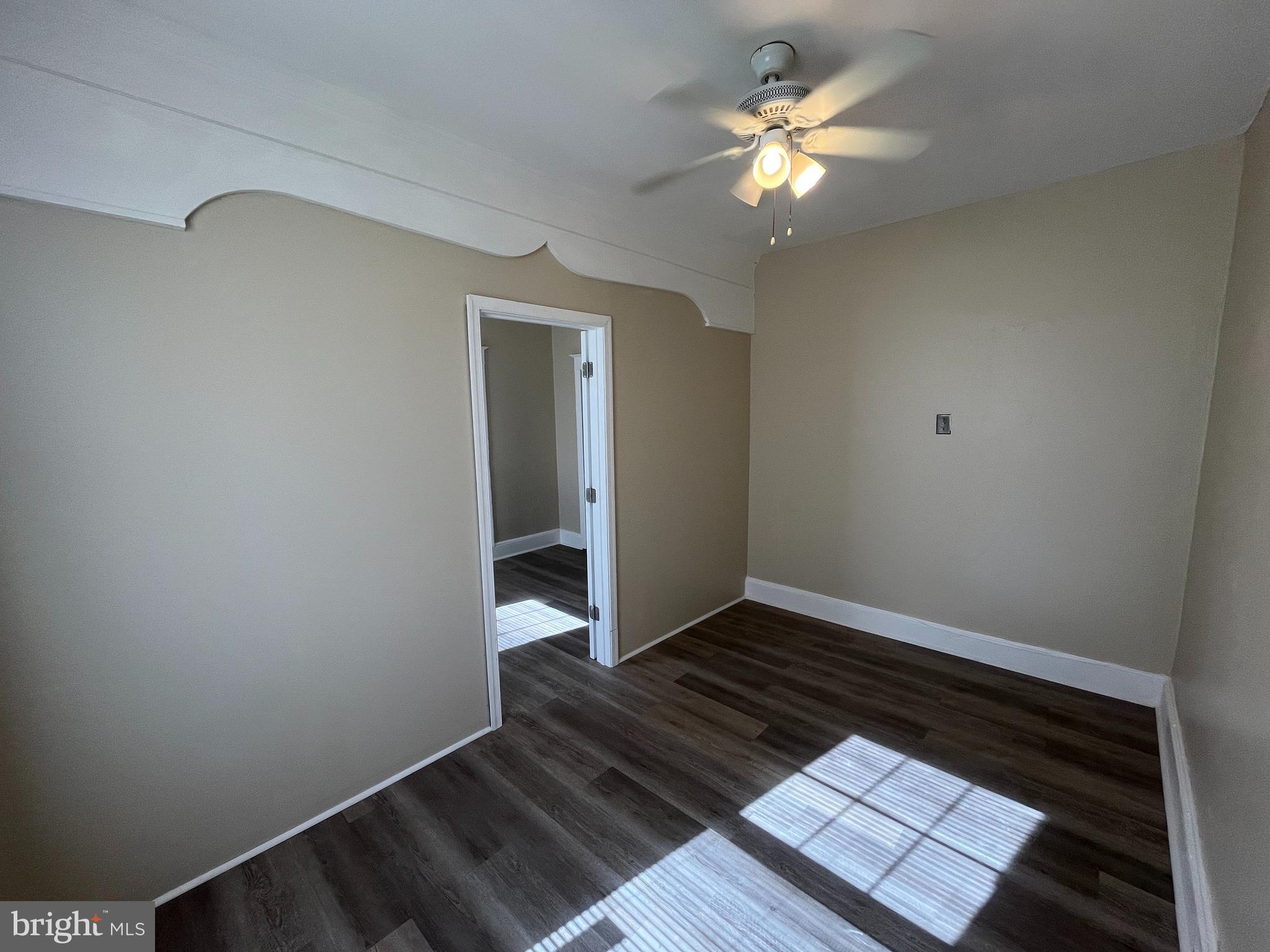 317 Reed Street, Unit 3F Philadelphia, PA 19147 - Photo 3 of 4 a view of an empty room with window and a ceiling fan