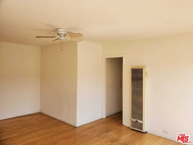 a view of a room with wooden floor