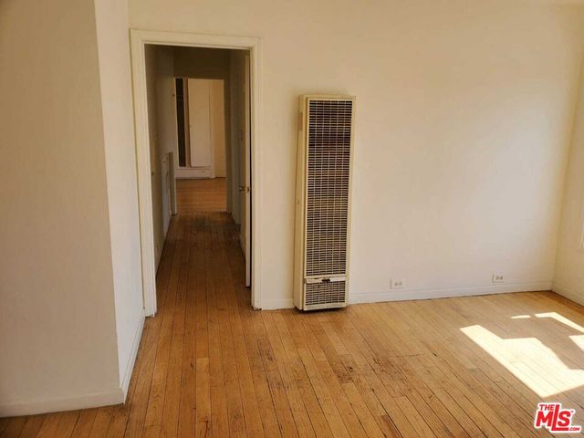 a view of a room with wooden floor and gate