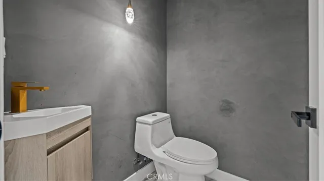 a white toilet sitting next to a white sink