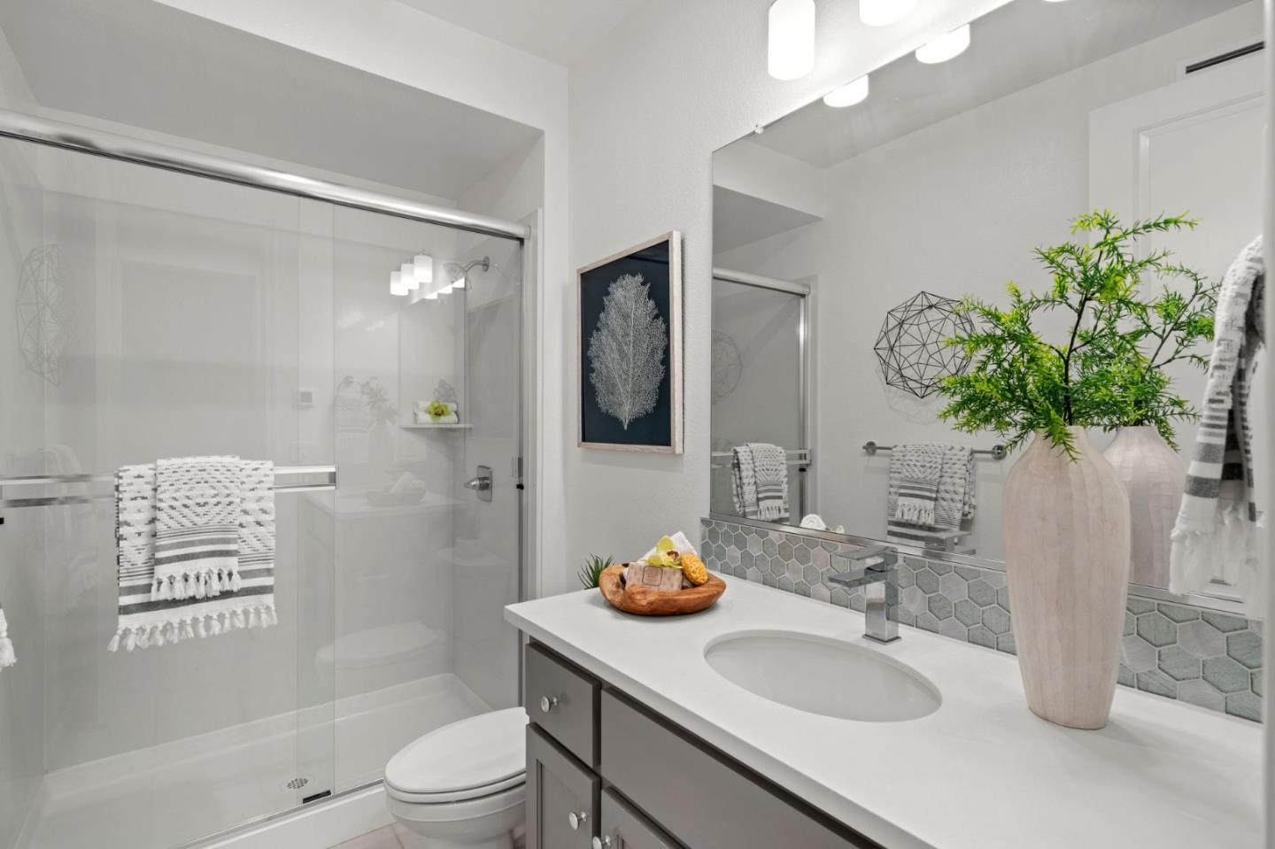 5465 Dublin Boulevard Dublin, CA 94568 - Photo 17 of 37 a bathroom with a granite countertop sink a toilet a mirror and shower