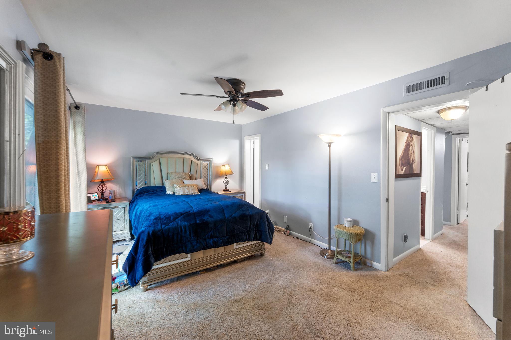 1636 Valencia Way Reston, VA 20190 - Photo 16 of 53 a bedroom with a bed a ceiling fan and a dresser