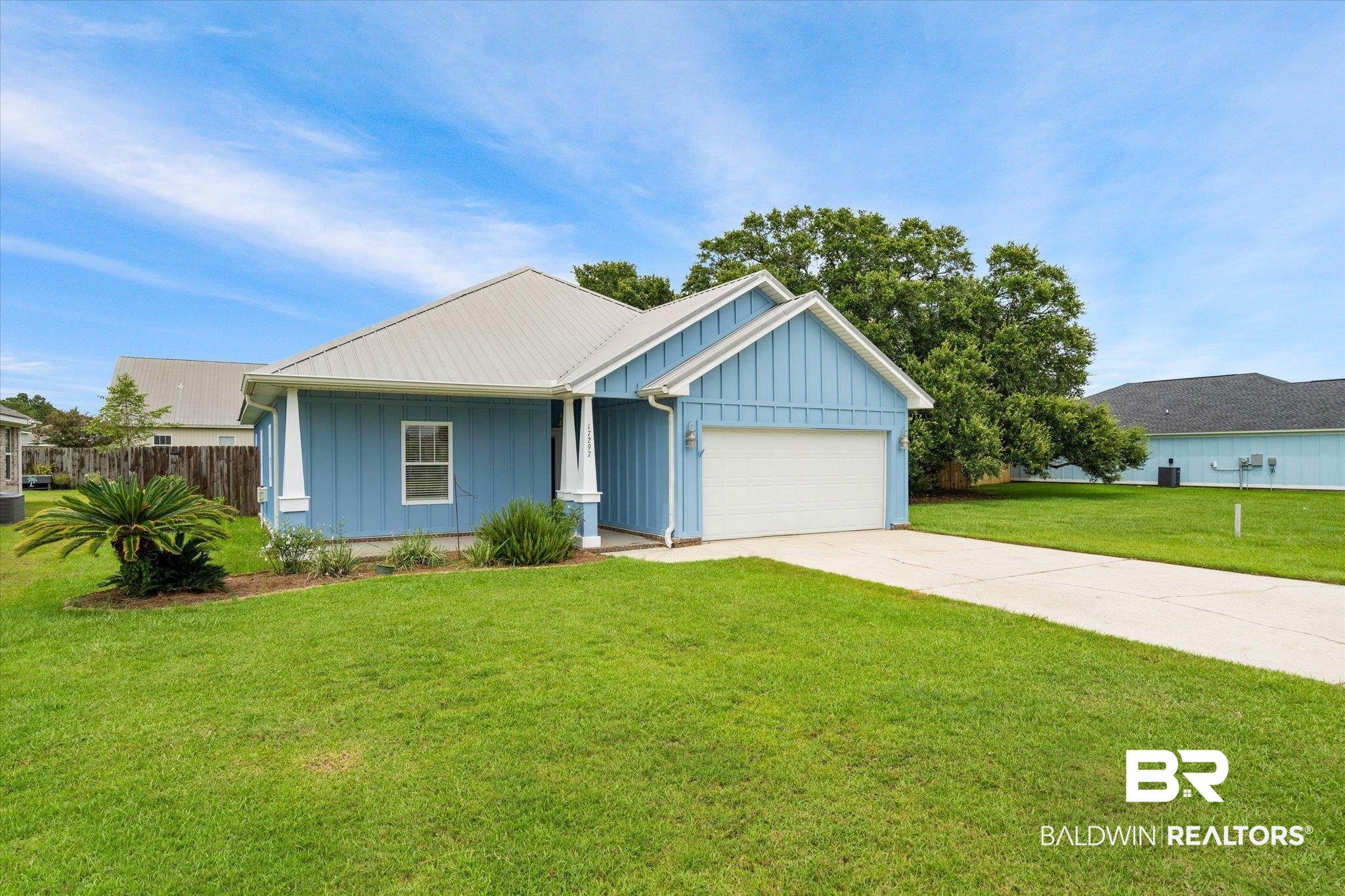 17297 Tallasee Boulevard Foley, AL 36535 - Photo 2 of 24 View of front of home with a garage and a front lawn