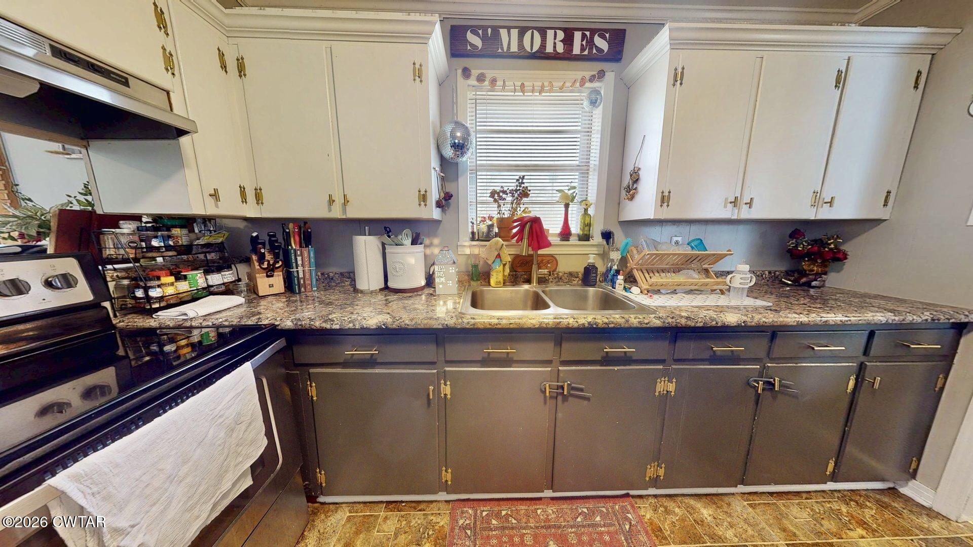 72 Palmer Subdivision Road Dyersburg, TN 38024 - Photo 6 of 14 a kitchen with stainless steel appliances granite countertop a sink and cabinets