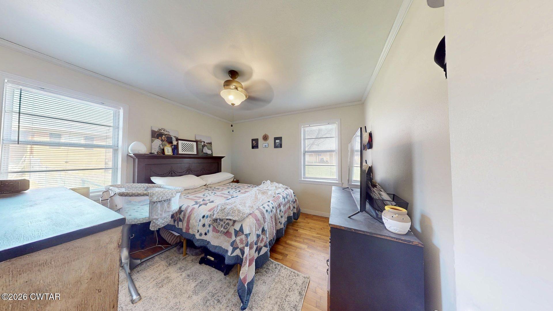 72 Palmer Subdivision Road Dyersburg, TN 38024 - Photo 7 of 14 a bedroom with a bed and a chandelier