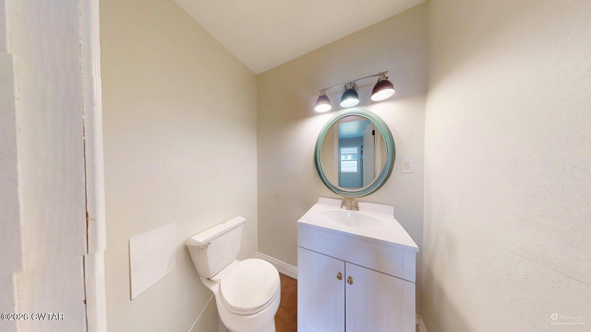 72 Palmer Subdivision Road Dyersburg, TN 38024 - Photo 8 of 14 a bathroom with a toilet a sink and a mirror