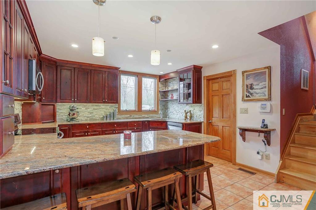 342 Pleasant Valley Road Old Bridge, NJ 08857 - Photo 2 of 25 a kitchen with stainless steel appliances granite countertop a table chairs sink and cabinets