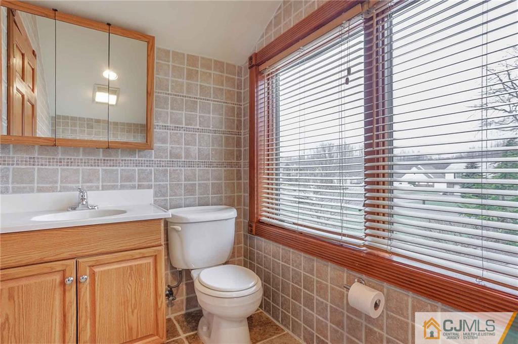 342 Pleasant Valley Road Old Bridge, NJ 08857 - Photo 13 of 25 a bathroom with a toilet a sink and mirror