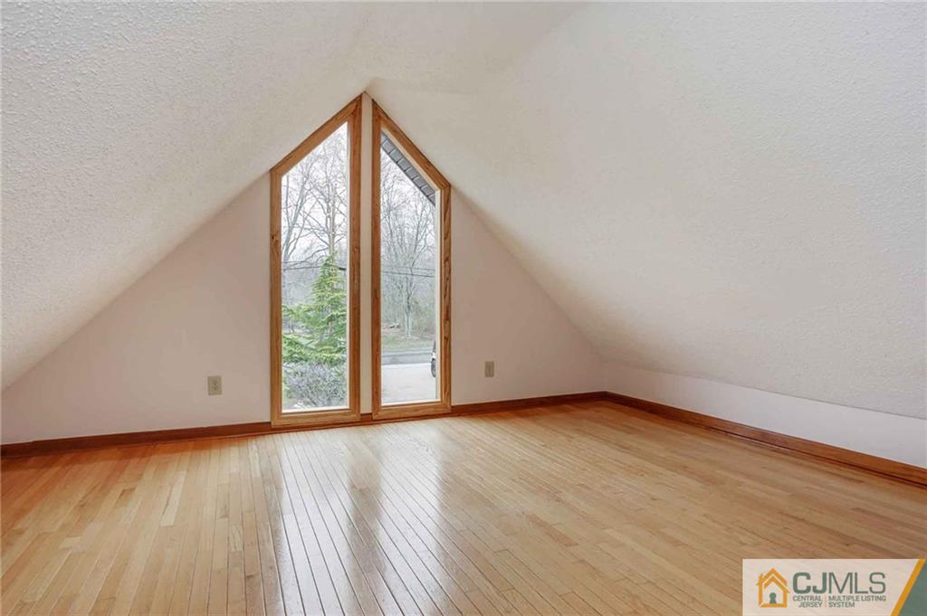 342 Pleasant Valley Road Old Bridge, NJ 08857 - Photo 19 of 25 a view of an empty room with wooden floor and a window
