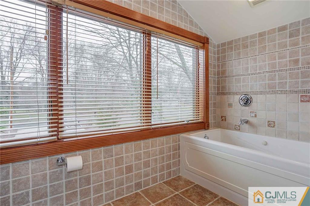 342 Pleasant Valley Road Old Bridge, NJ 08857 - Photo 20 of 25 a bathroom with a bathtub and next to a window
