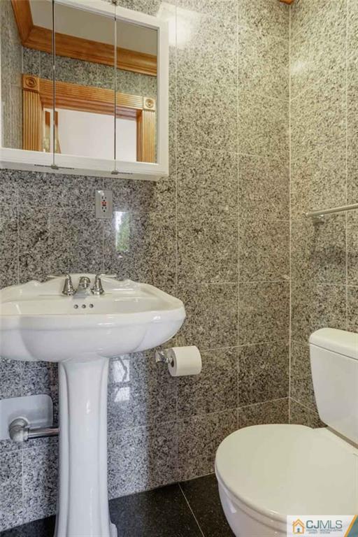 342 Pleasant Valley Road Old Bridge, NJ 08857 - Photo 22 of 25 a bathroom with a sink a toilet and shower