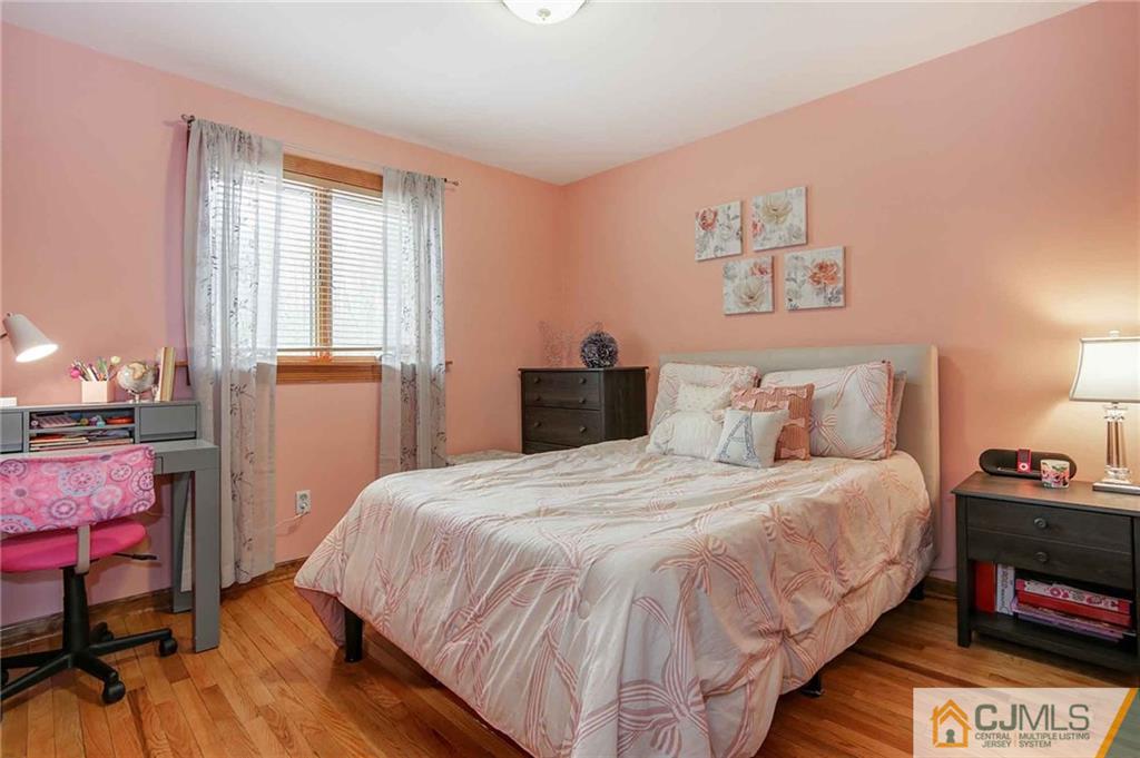 342 Pleasant Valley Road Old Bridge, NJ 08857 - Photo 5 of 25 a bedroom with a bed and wooden floor