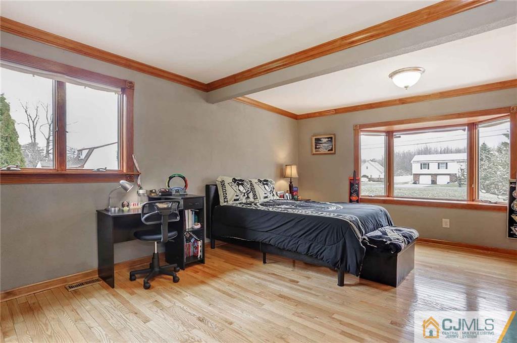 342 Pleasant Valley Road Old Bridge, NJ 08857 - Photo 6 of 25 a bed room with a bed and a desk