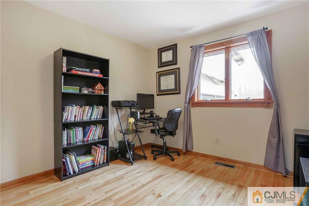 342 Pleasant Valley Road Old Bridge, NJ 08857 - Photo 7 of 25 a view of a workspace with furniture and a window