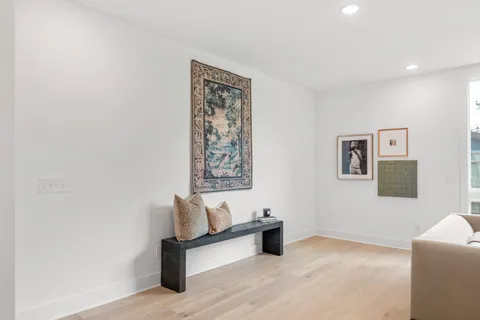 a living room with furniture and a wall painting