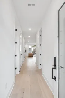 a view of a hallway with wooden shelves