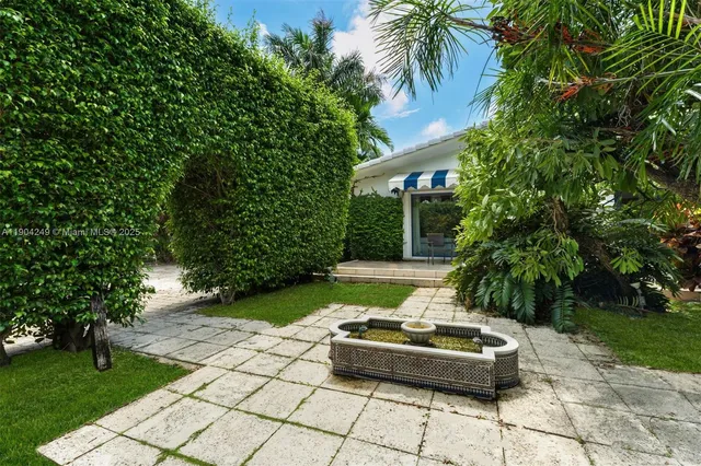 a view of a patio with table and chairs and potted plants
