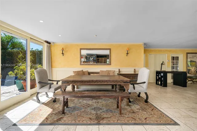 a view of a yard with plants and a palm tree