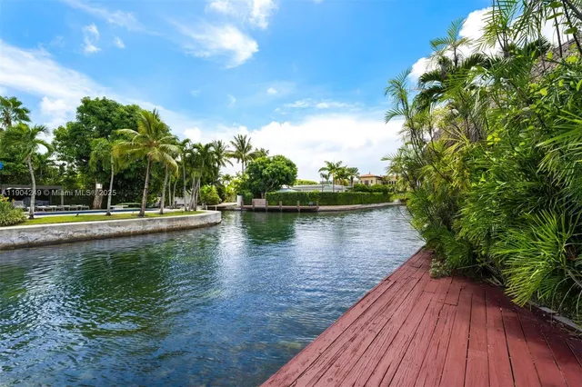 a living room with furniture large window and flat screen tv