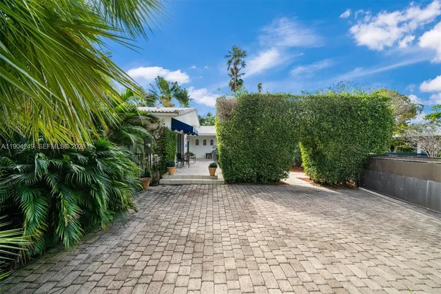 a living room with furniture a rug and a large window