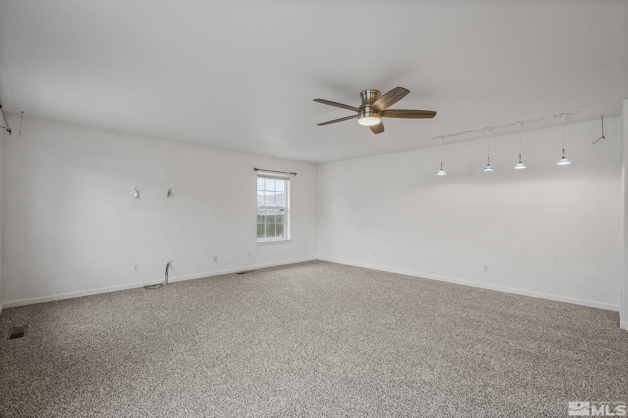 15560 North Red Rock Road Reno, NV 89508 - Photo 12 of 28 an empty room with a window and a ceiling fan
