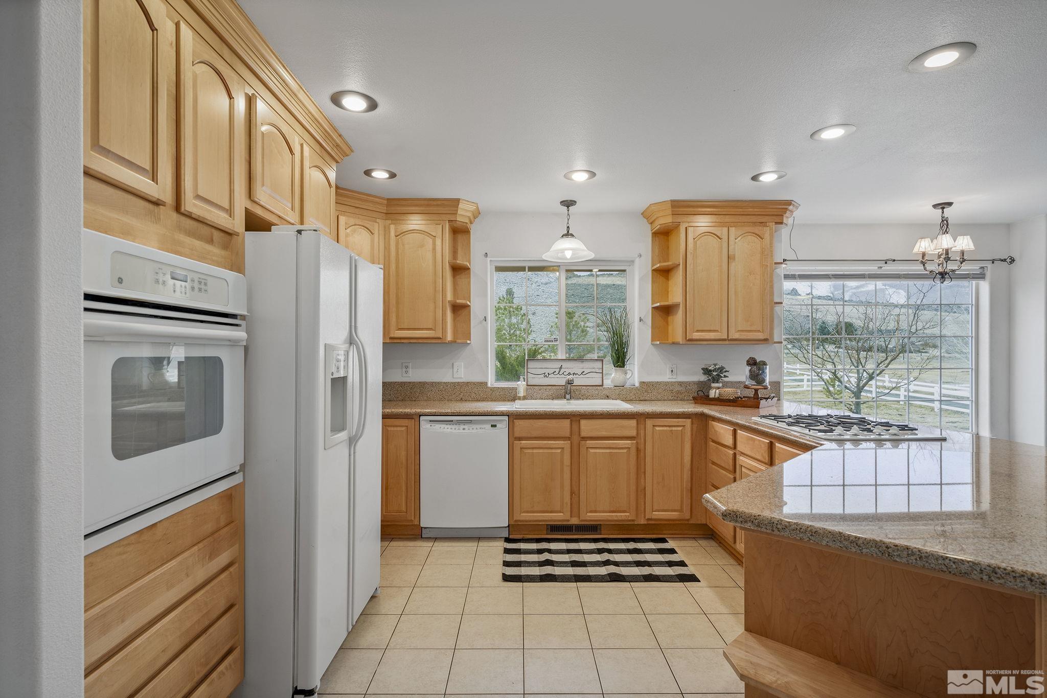 15560 North Red Rock Road Reno, NV 89508 - Photo 14 of 28 a kitchen with stainless steel appliances granite countertop a refrigerator and a stove