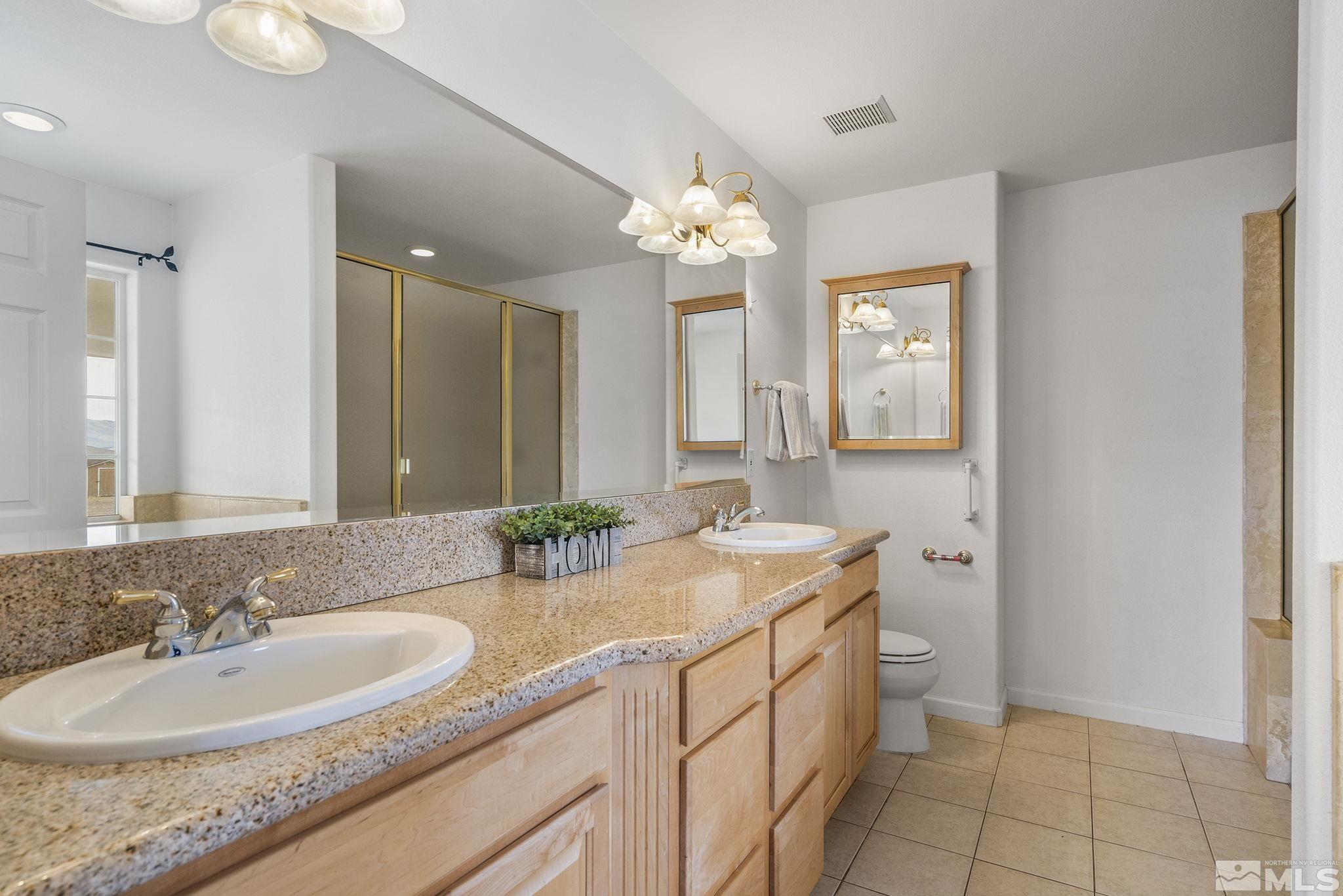 15560 North Red Rock Road Reno, NV 89508 - Photo 18 of 28 a bathroom with a sink a vanity and a mirror