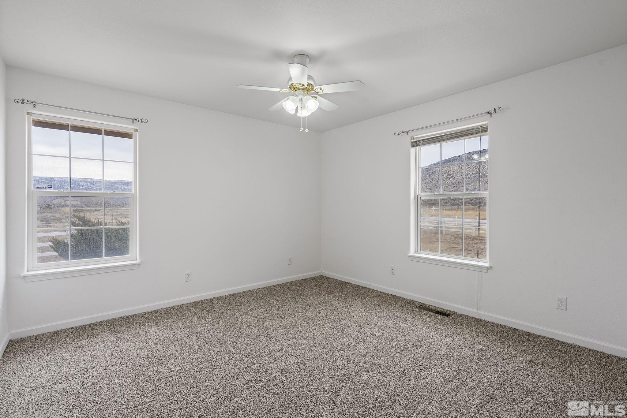 15560 North Red Rock Road Reno, NV 89508 - Photo 20 of 28 an empty room with a window and a fan