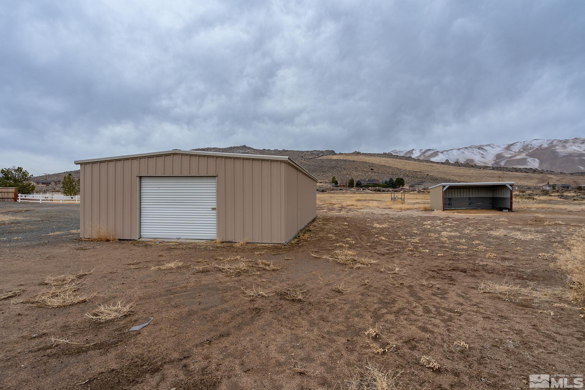 15560 North Red Rock Road Reno, NV 89508 - Photo 24 of 28 a view of a dry yard with a barn