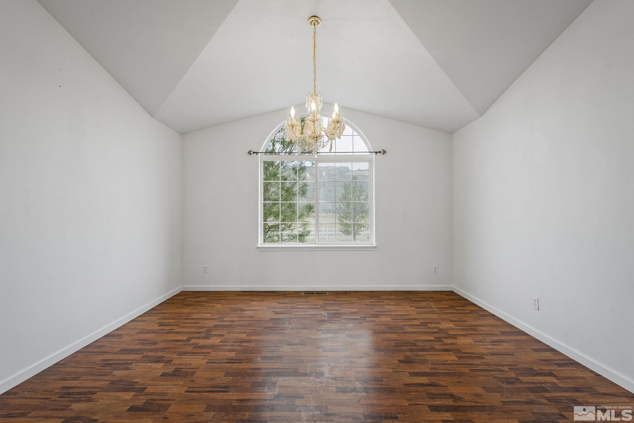 15560 North Red Rock Road Reno, NV 89508 - Photo 7 of 28 a view of an empty room with wooden floor and a window