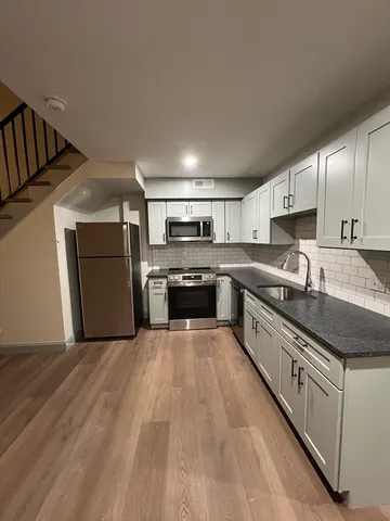 a view of kitchen with cabinets and wooden floor