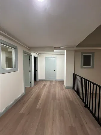 a view of a livingroom with wooden floor and window