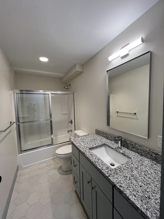 160 Seabury Street, Unit 31 Fall River, MA 02720 - Photo 14 of 14 a bathroom with a granite countertop sink a toilet and a shower
