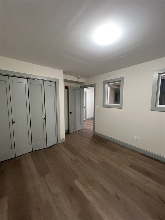 160 Seabury Street, Unit 31 Fall River, MA 02720 - Photo 10 of 14 a view of an empty room with wooden floor and a window