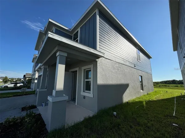 a view of house with backyard space and garden