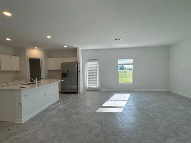 a view of a kitchen with a sink and a window