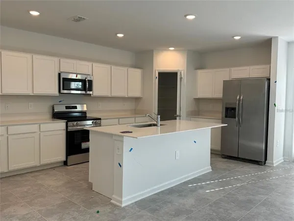 a kitchen with a refrigerator sink and microwave