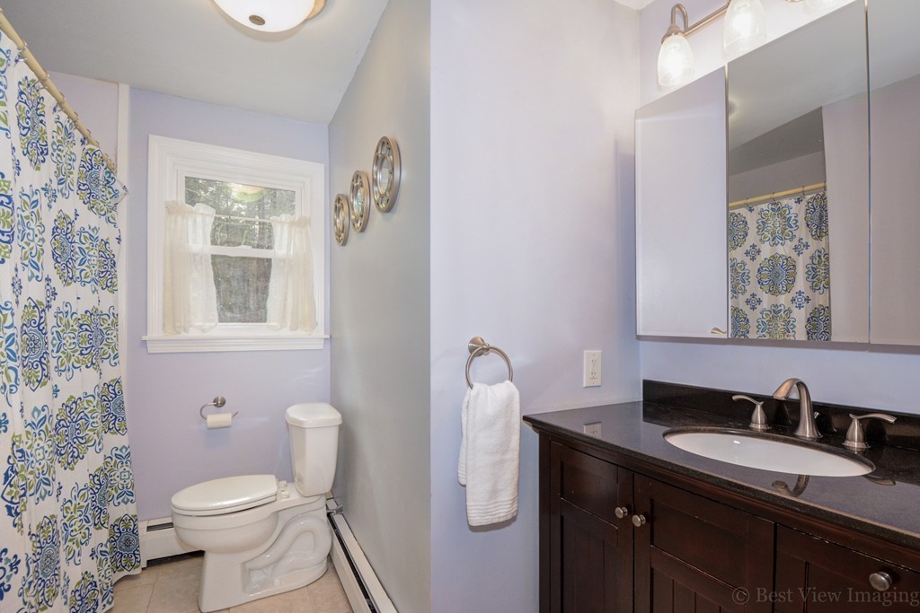 86 Harvard Road Stow, MA 01775 - Photo 16 of 19 a bathroom with a granite countertop toilet sink and mirror