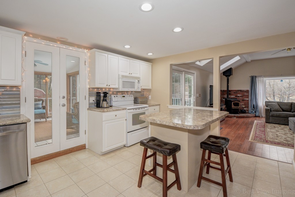 86 Harvard Road Stow, MA 01775 - Photo 3 of 19 a kitchen with stainless steel appliances granite countertop a stove a sink a refrigerator and a granite counter tops