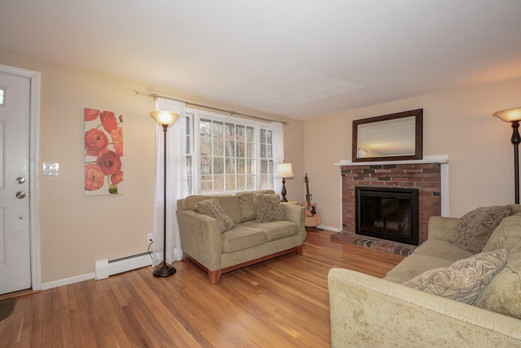 86 Harvard Road Stow, MA 01775 - Photo 7 of 19 a living room with furniture and a fireplace