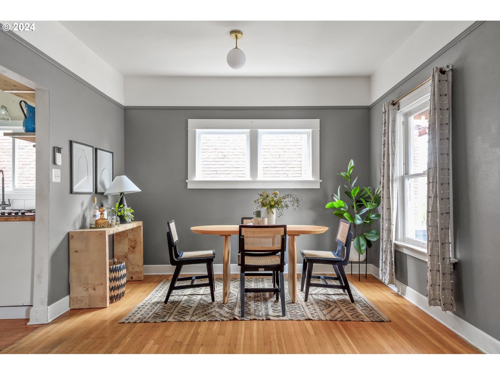 1518 North Webster Street Portland, OR 97217 - Photo 8 of 38 a dining room with furniture potted plants and wooden floor